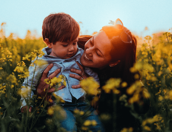 Woman with a child playing in the fields