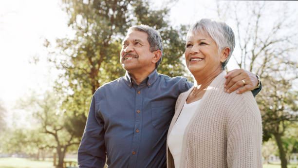 A patient who has decided to participate in a lung cancer study hugs his wife and smiles.