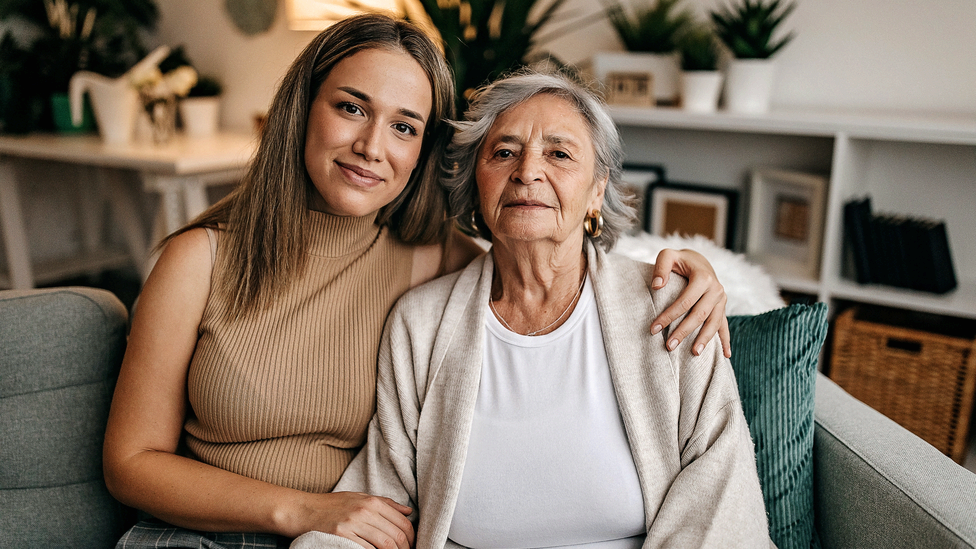 A smiling caregiver hugs a patient who has learned about a cancer research study she may qualify for.