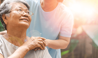 Doctor comforting elderly lady