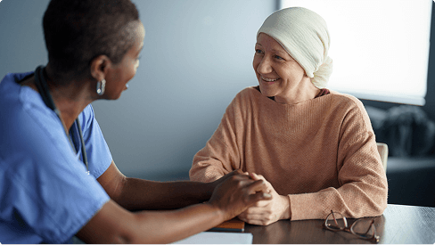A nurse discusses a cancer clinical study with a patient in the study.