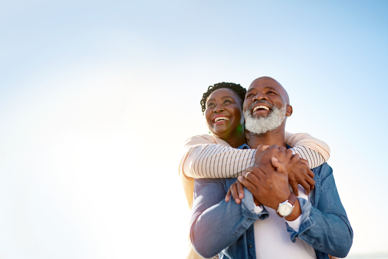 A woman embraces her husband after he decides to participate in a prostate cancer clinical study.