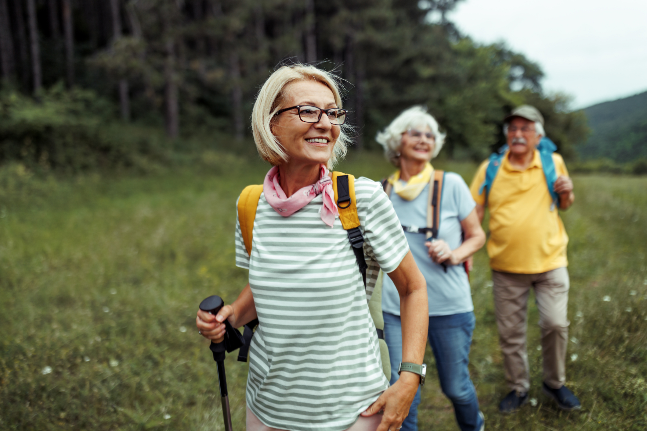 A woman hikes with two friends after participating in a colorectal cancer clinical study.