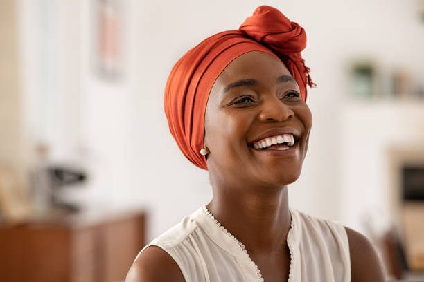 A woman with a headscarf in a lupus clinical study smiles.