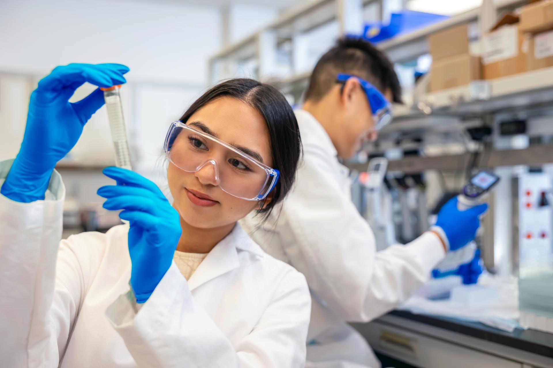 Two researchers work in a lab as part of a cancer clinical study.